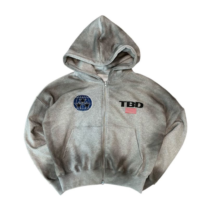 TOM'S BIRTHDAY（トムズバースデー）の「TBD World Logo Spray Hoodie Zipup Grey（Tops）」