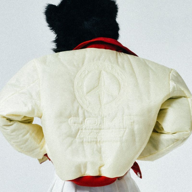 C.O.M.E（シーオーエムイー）の「[UNISEX] Reversible "WORLD PEACE" Padded Bomber Jacket (Light Yellow)（Jackets/Outerwear）」