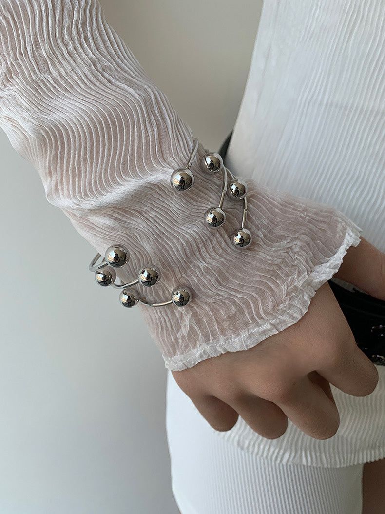 Silver ball piercing bangle
