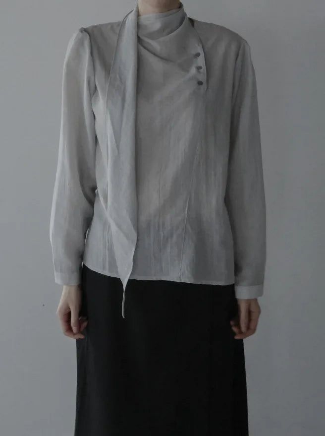 mnem（ムネム）の「Noir Unbalance Button Scarf Blouse（Tops）」