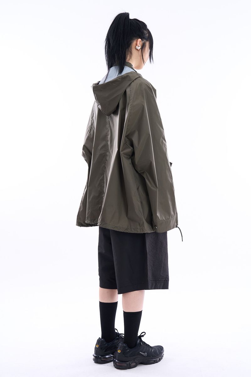 Fishtail raglan over raincoat