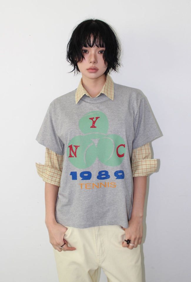 AAKE(アケ)の「VINTAGE TENNIS GRAPHIC TEE(Tops)」