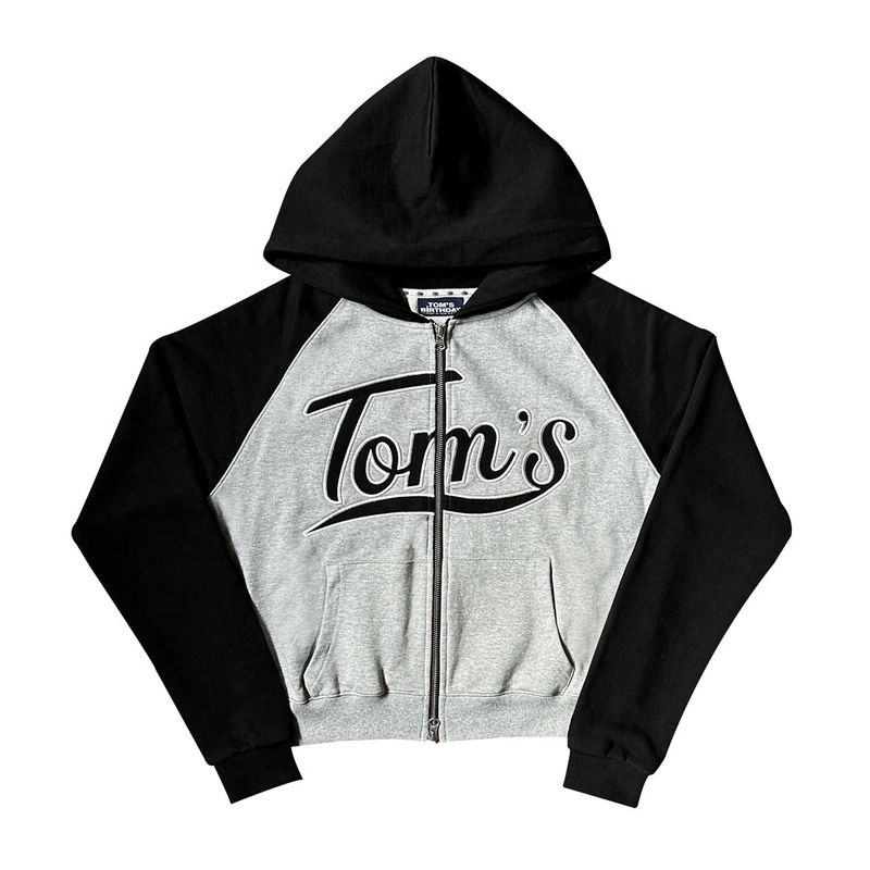 TOM'S BIRTHDAY（トムズバースデー）の「TOMS RAGLAN MIX HOOD ZIPUP BLACK（Tops）」