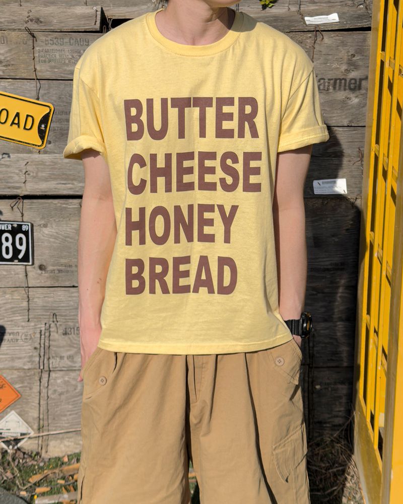 JIIGEUM(ジグム)の「Tasty Graphic Short Sleeve T-Shirt(Tops)」