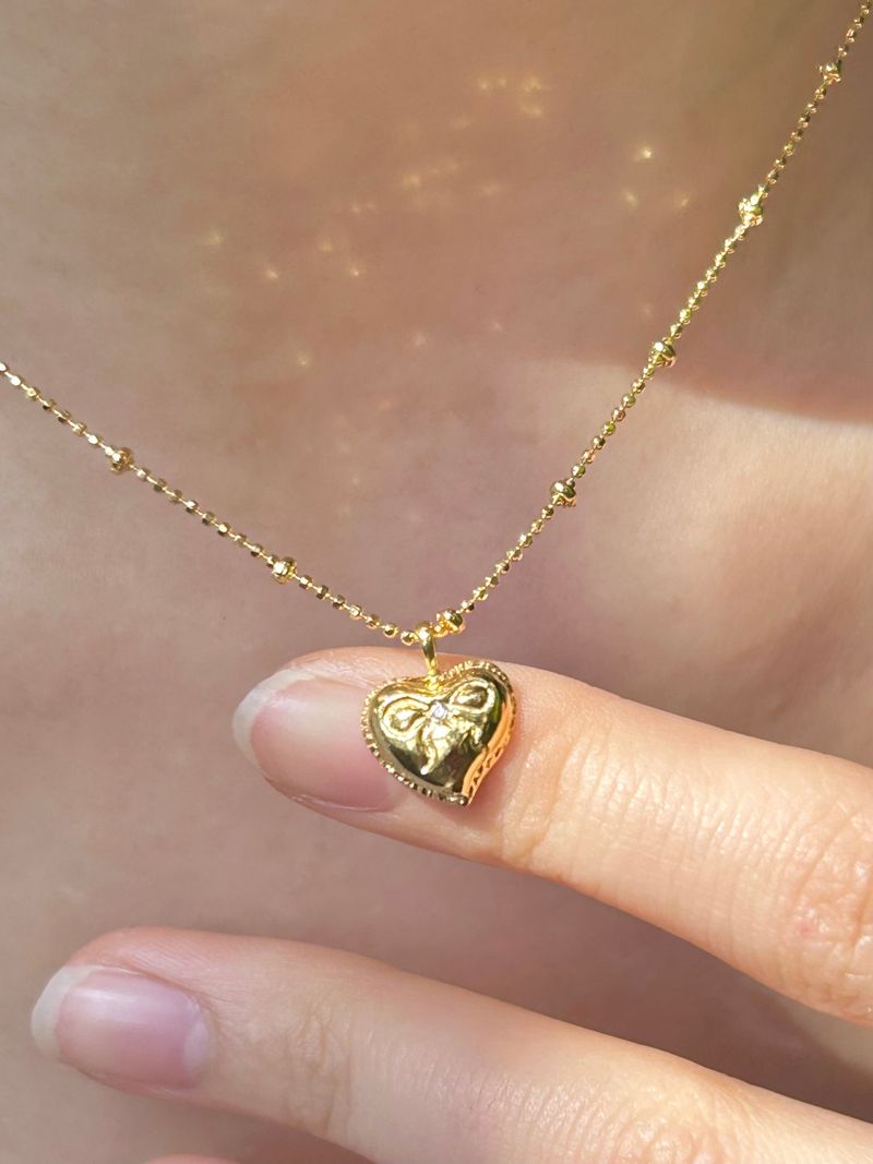 DANI(ダニ)の「リボンハートN(14Kメッキ)(アクセサリー)」