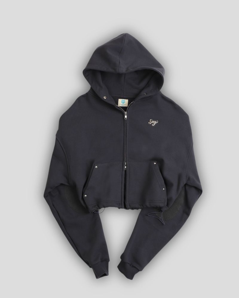 SAYSAYSAY（セイセイセイ）の「Silver Logo Docking Crop Hood Zip-Up Charcoal（Tops）」
