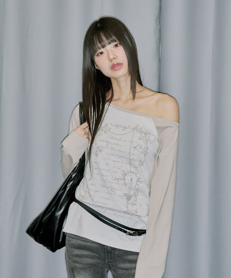 ODDSTUDIO（オッドスタジオ）の「Cross Ornament Off Shoulder Raglan Long Sleeve - GRAY BEIGE（Tops）」
