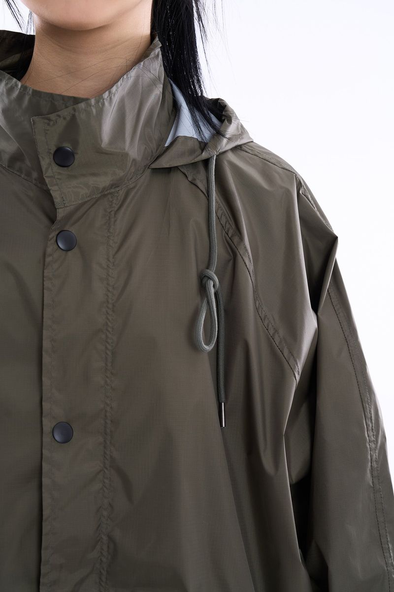 Fishtail raglan over raincoat