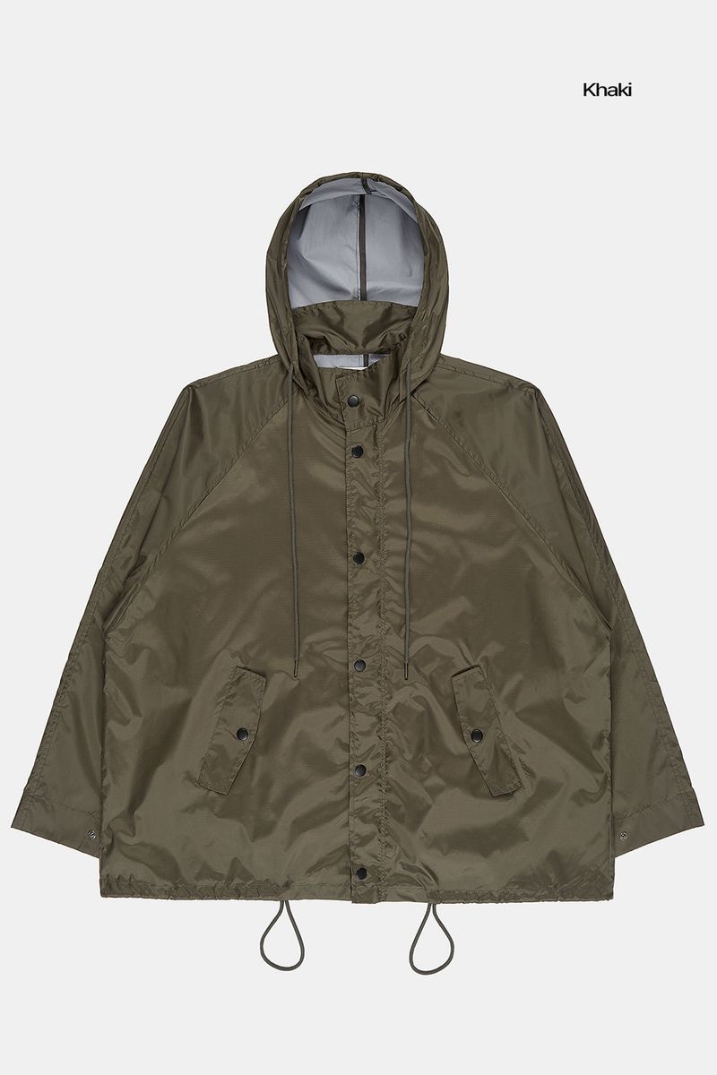 Fishtail raglan over raincoat