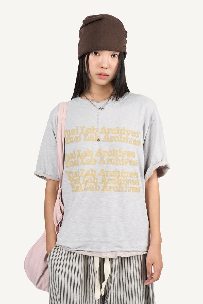 Raucohouse（ラウコハウス）の「Layered Archive Short Sleeve T-shirt（Tops）」