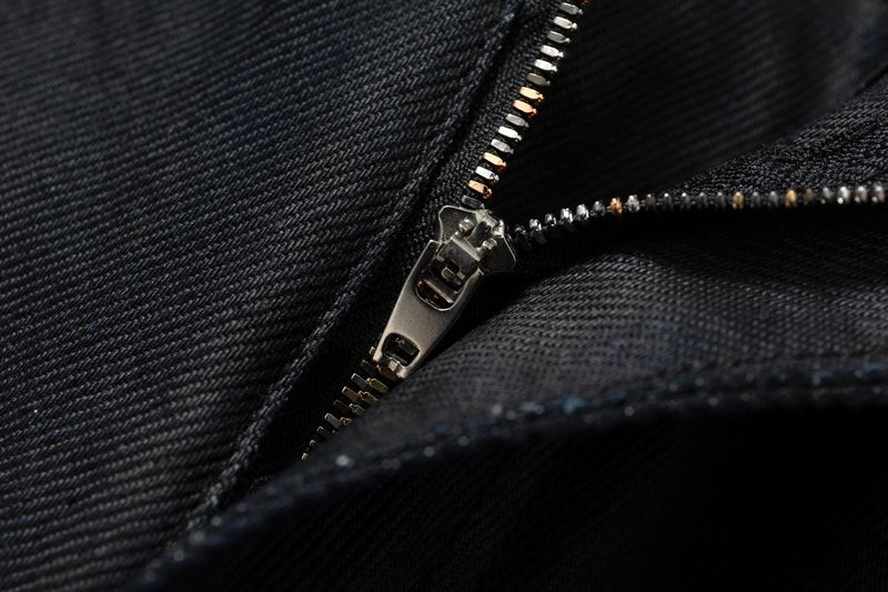 COATED KNIFE-SCRAPED HAND-WIPED DISTRESSED BOOTCUT JEANS