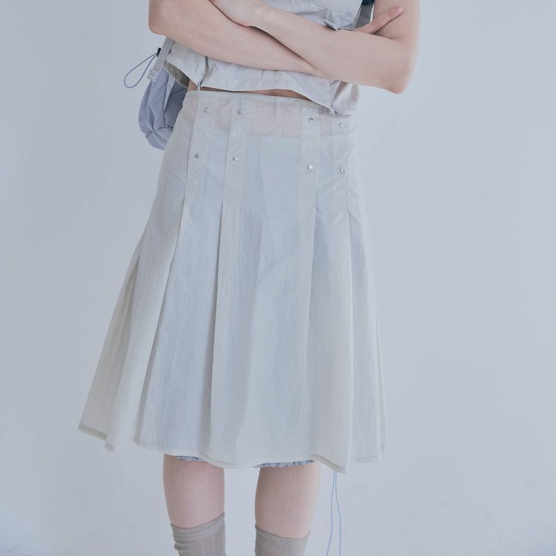 poie(ポイエ)の「sheer layered rivet pleats skirt (beige)(Skirts)」