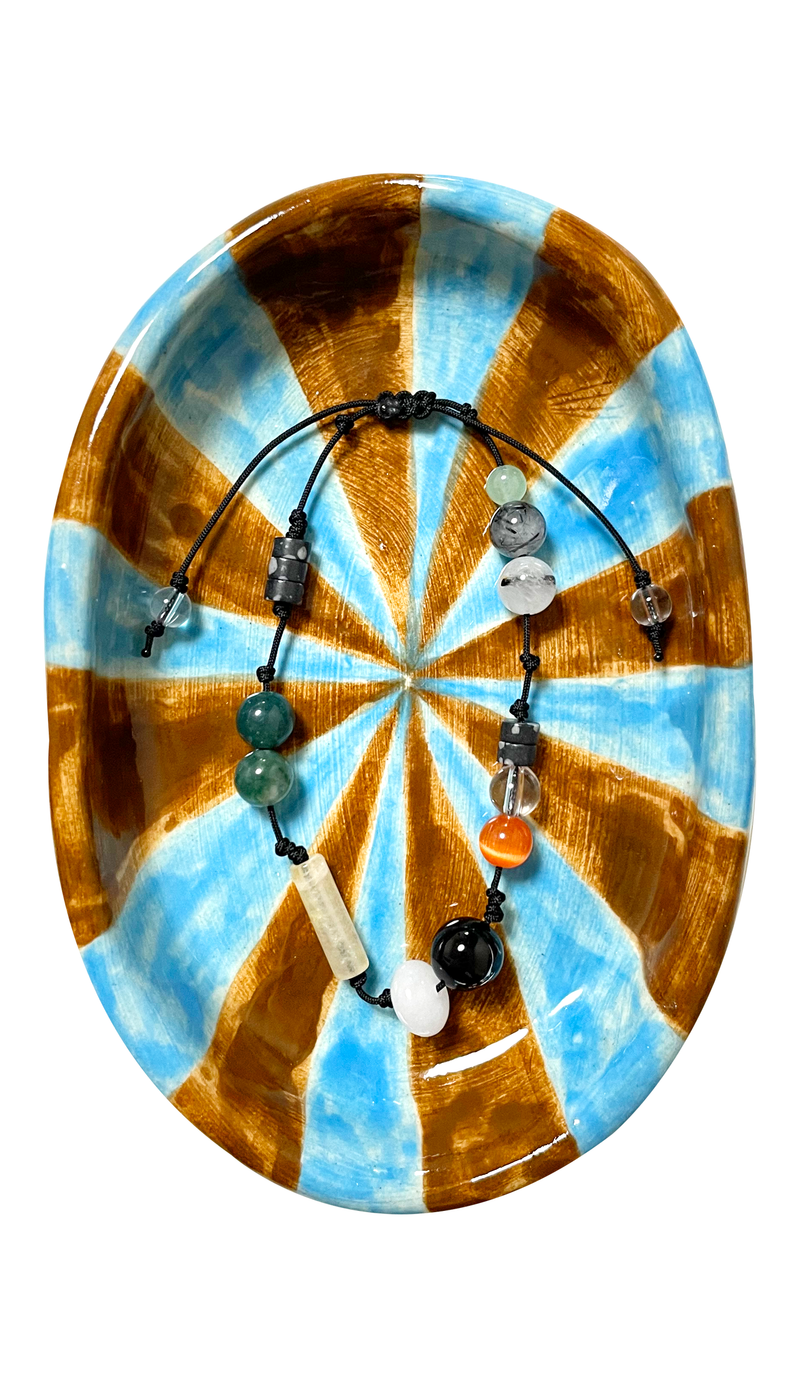 A fish in a water plant gemstone bracelet