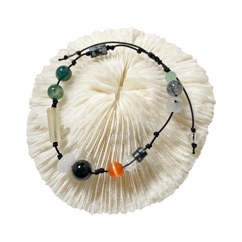 A fish in a water plant gemstone bracelet