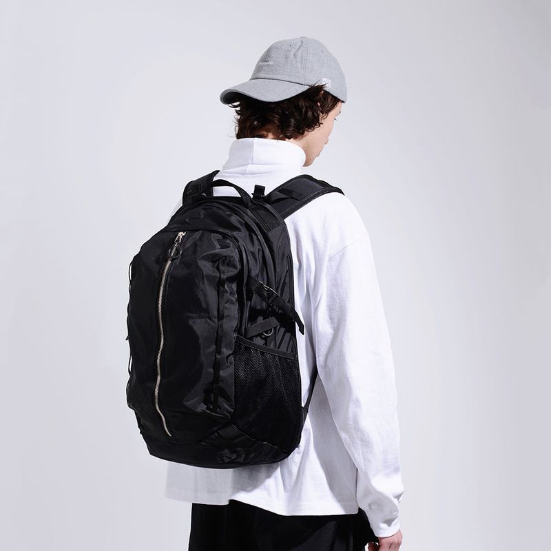 PIECEMAKER(ピースメーカー)の「NYLON ZIP SQ BACKPACK (BLACK)(Bags)」