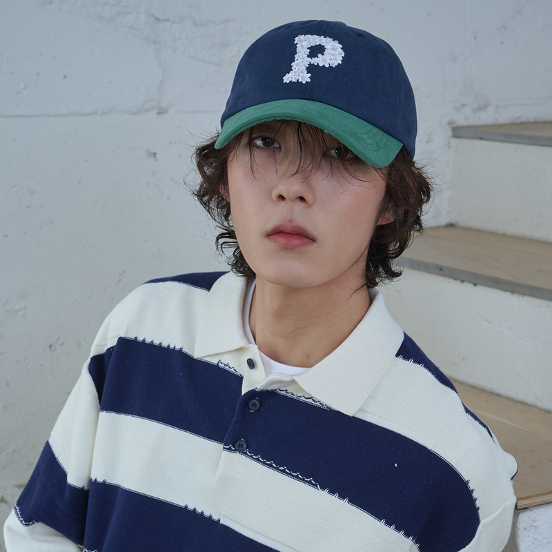 ALLINCOMPLETE（オールインコンプリート）の「フローラル Pロゴ ボールキャップ (Green & Navy)（帽子）」
