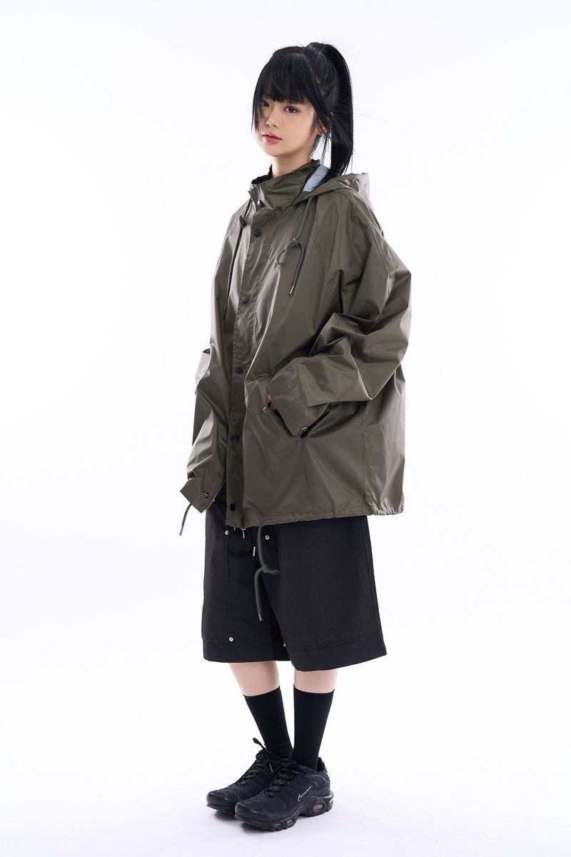 Fishtail raglan over raincoat