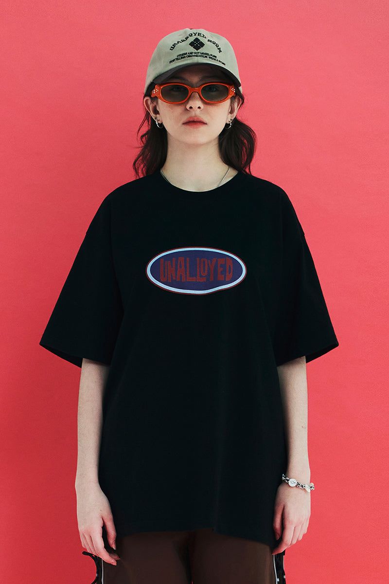 UNALLOYED(アナロイド)の「OVAL LOGO T SHIRT / BLACK(Tops)」