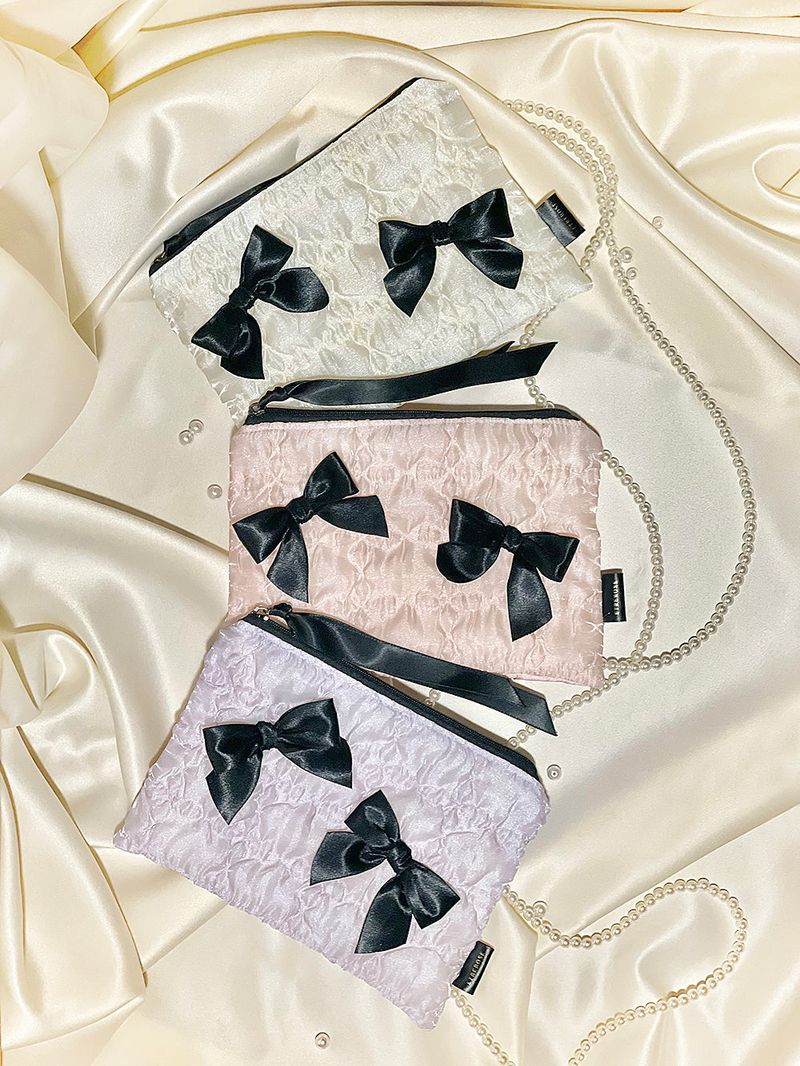 ETREROSE（エトレロゼ）の「グロッシーオーガンザリボンジップポーチ (M)（スマホグッズ/小物）」
