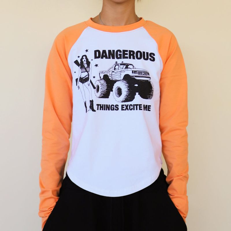 KRUCHI(クルチ)の「DANGEROUS Raglan long-sleeved T-Shirt (WHITE ORANGE) WOMENS(Tops)」