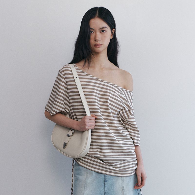 Curetty（キュリティ）の「CサイドシャーリングオフショルダーTシャツ - ベージュ（トップス）」