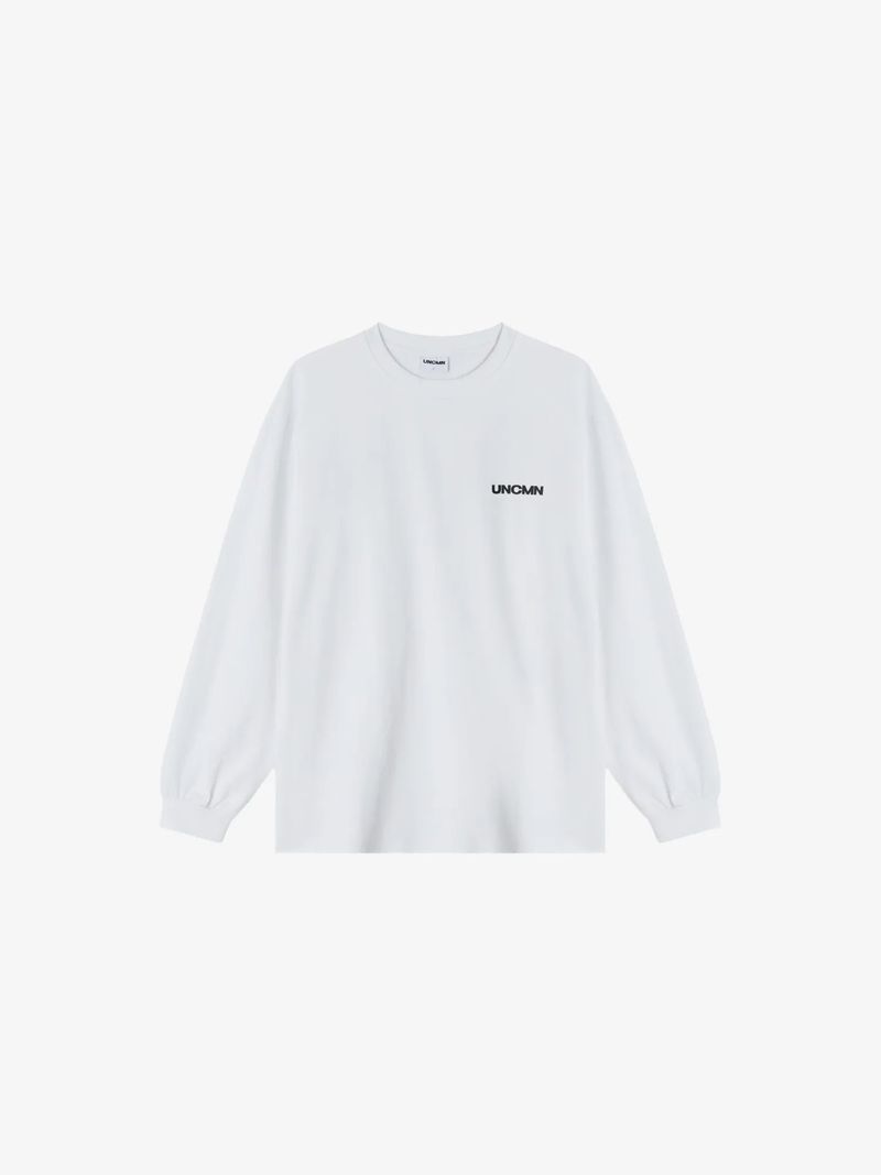 UNCMN（アンカモン）の「ロゴ ロングスリーブ ホワイト（トップス）」