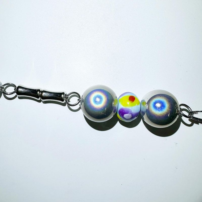 Pierced ball bag chain