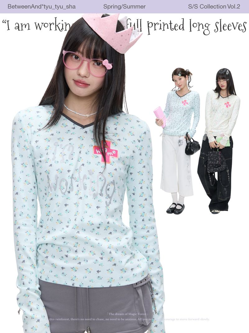 BETWEENAND（ビトゥウィーンアンド）の「BETWEENAND「Music Box Melody」Spring: a loose-long-sleeved T-shirt with a V-neck and various prints, worn while working（Tops）」