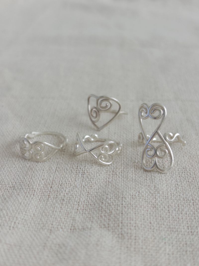 PAIR OF LOVE（ペアオブラブ）の「セビル ハート ローリング リング（アクセサリー）」