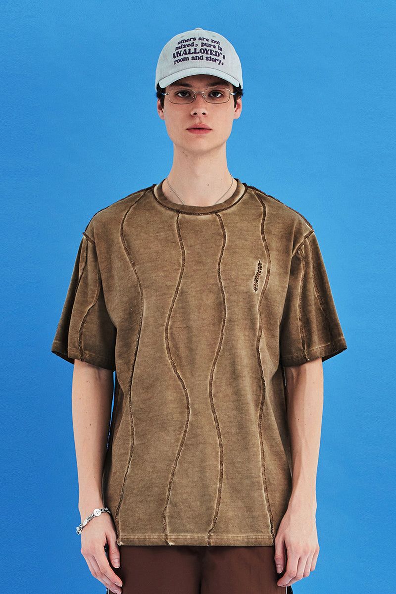 UNALLOYED（アナロイド）の「DYED WAVE OVERLOCK T SHIRT / BEIGE（Tops）」