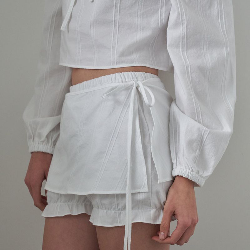 OVT-U(オーブイティーユー)の「Mellow Ribbon Wrap Skirt_White(Skirts)」