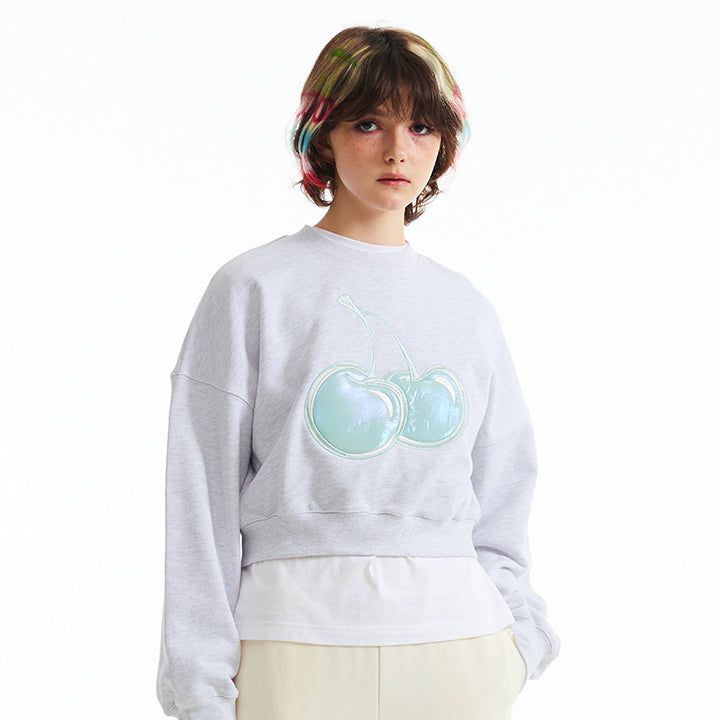KIRSH（キルシー）の「BIG CHERRY HOLOGRAM CROP SWEATSHIRT [MELANGE GRAY]（Tops）」