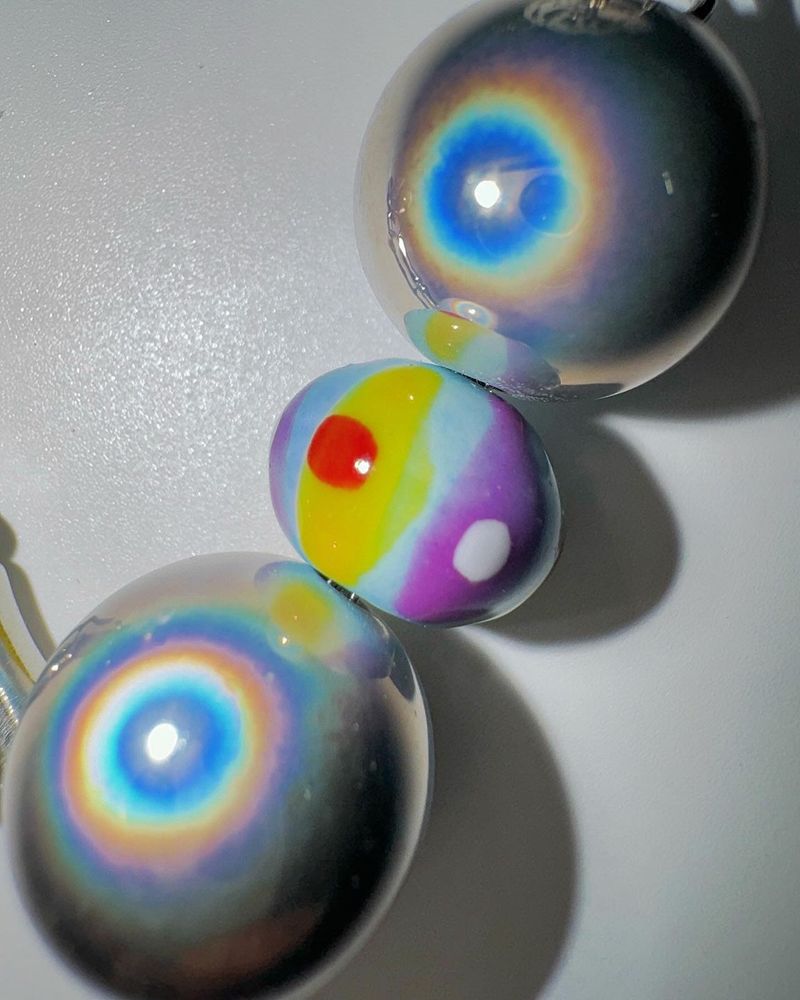Pierced ball bag chain