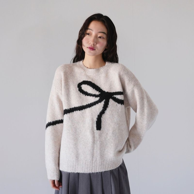 Uenui（ウニュイ）の「flow diagonally ribbon knit（Tops）」