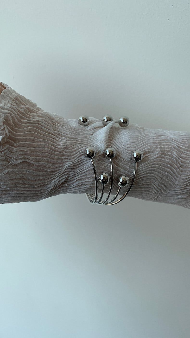 Silver ball piercing bangle