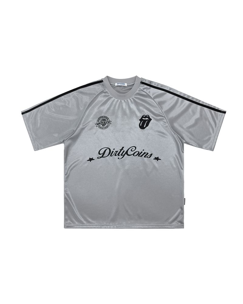 DirtyCoins（ダーティーコインズ）の「DC x The Rolling Stones Logo Glossy Soccer Jersey Grey（Tops）」