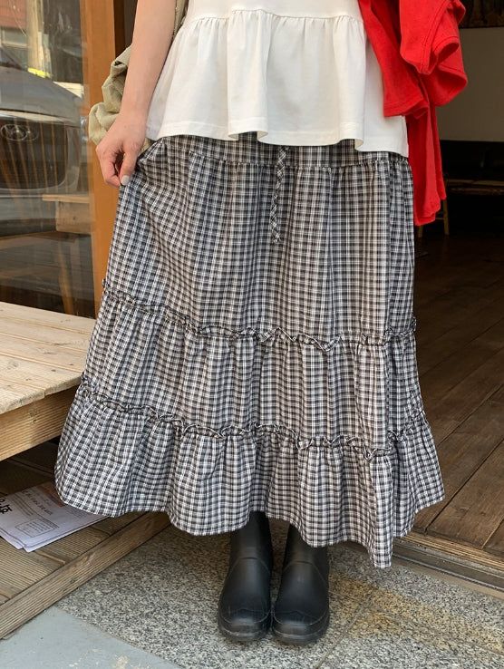 BAON（バオン）の「Cayue Check Shirring Tiered Banding Long Skirt（Skirts）」
