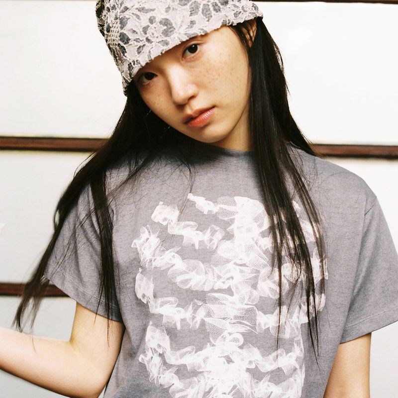 WEBHOUSE（ウェブハウス）の「Lace Bone Angel Tee - Charcoal（Tops）」