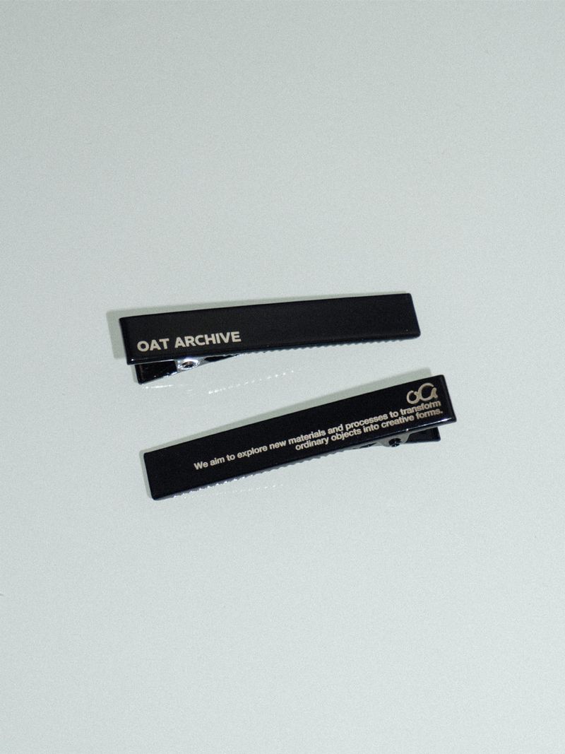 Black logo hair pin