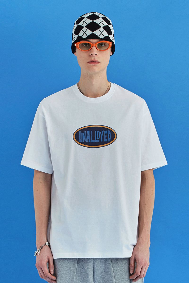 UNALLOYED（アナロイド）の「OVAL LOGO T SHIRT / WHITE（Tops）」