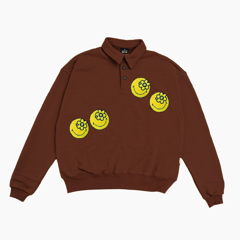 Water The Plant（ウォーターザプラント）の「SMILEYWORLD® ENCHANTING L/S POLO | BROWN（Tops）」