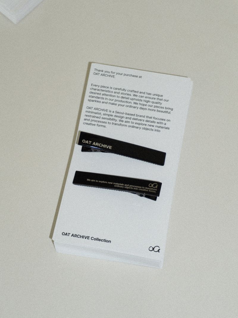 Black logo hair pin